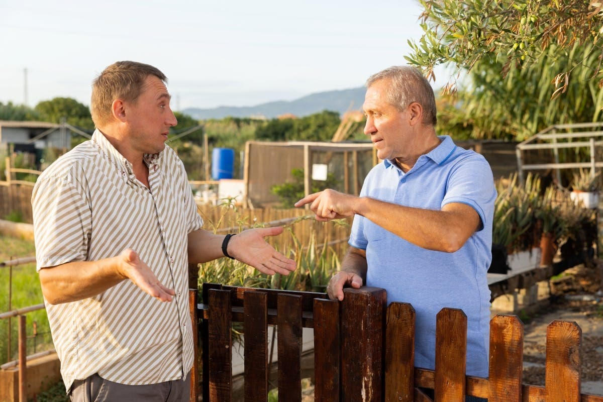 Two older men arguing over a land dispute